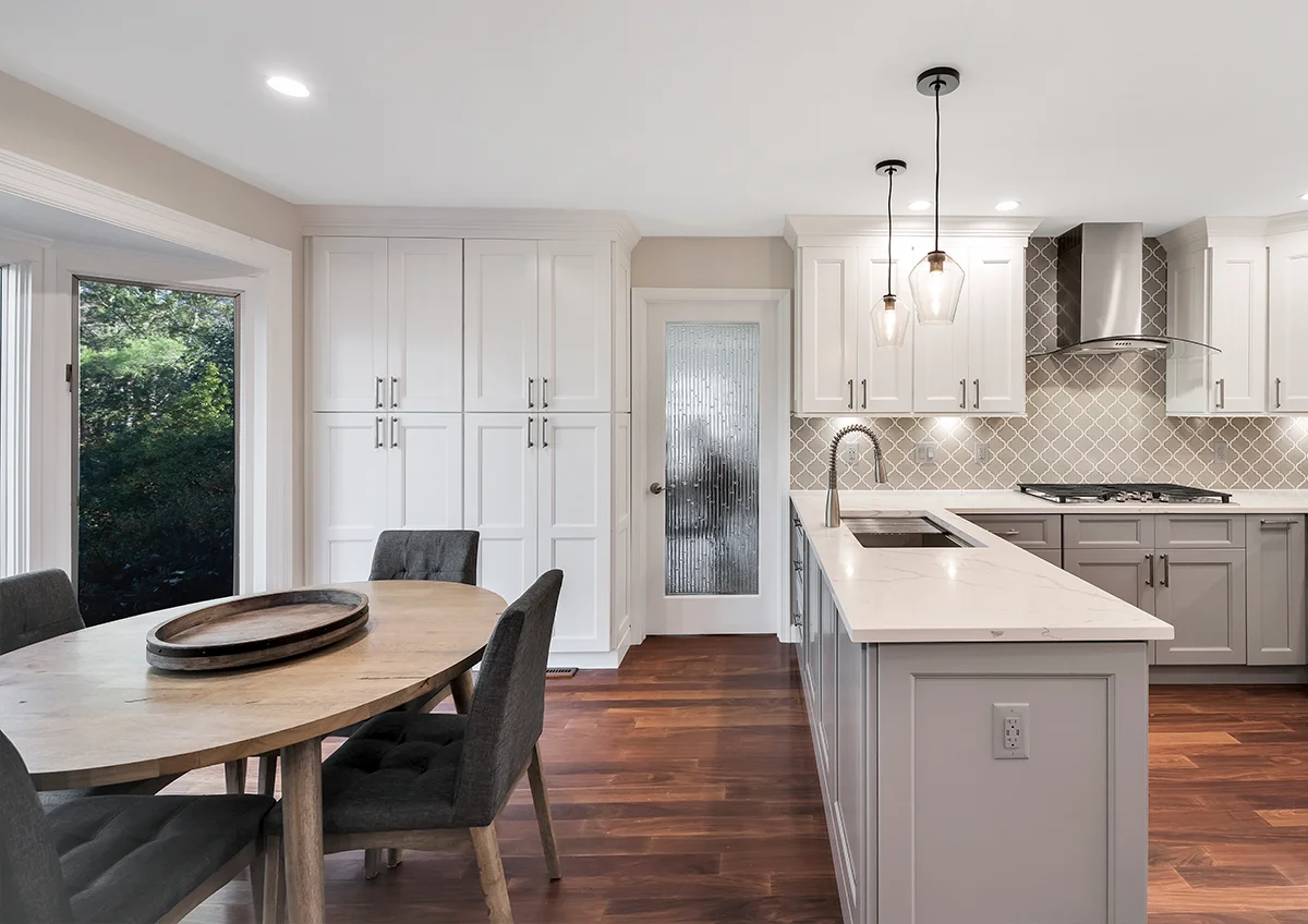 Chic kitchen remodel highlighting dark espresso cabinets, elegant pendant lighting, and a roomy kitchen island near Alexandria, VA.